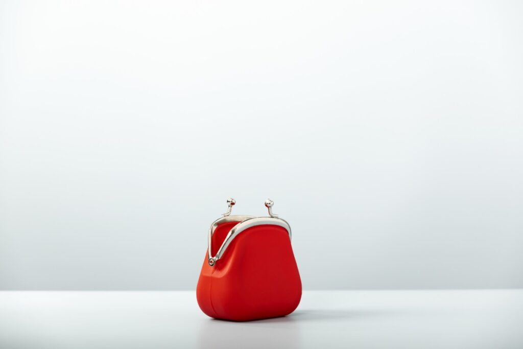 Tech IPOs and Deals: Startup Weekly Roundup of Key Acquisitions and Funding An open red coin purse pictured against a white background
