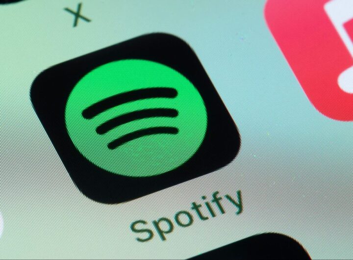 Spotify, Apple Music on smart phone screen.