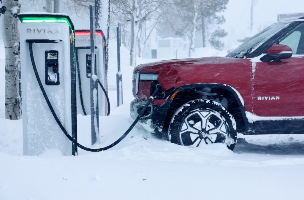 Rivian Cuts Delivery Guidance Due to Trump's Tariffs and Trade Wars Rivian Electric Car Charging Station, in winter